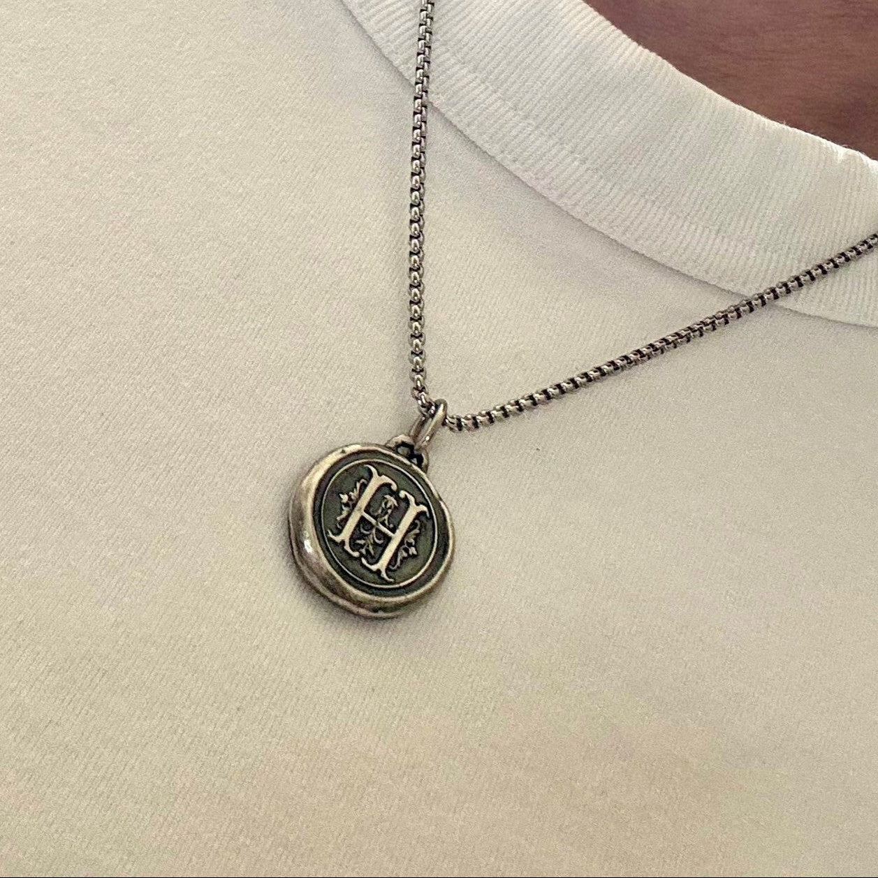 Medieval stamp Coin Charm | Ona Chan Jewelry with oxidation on white t shirt