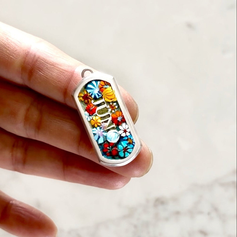 Sterling silver dog tag custom made with Millefiori beads held on fingers | Ona Chan Jewelry