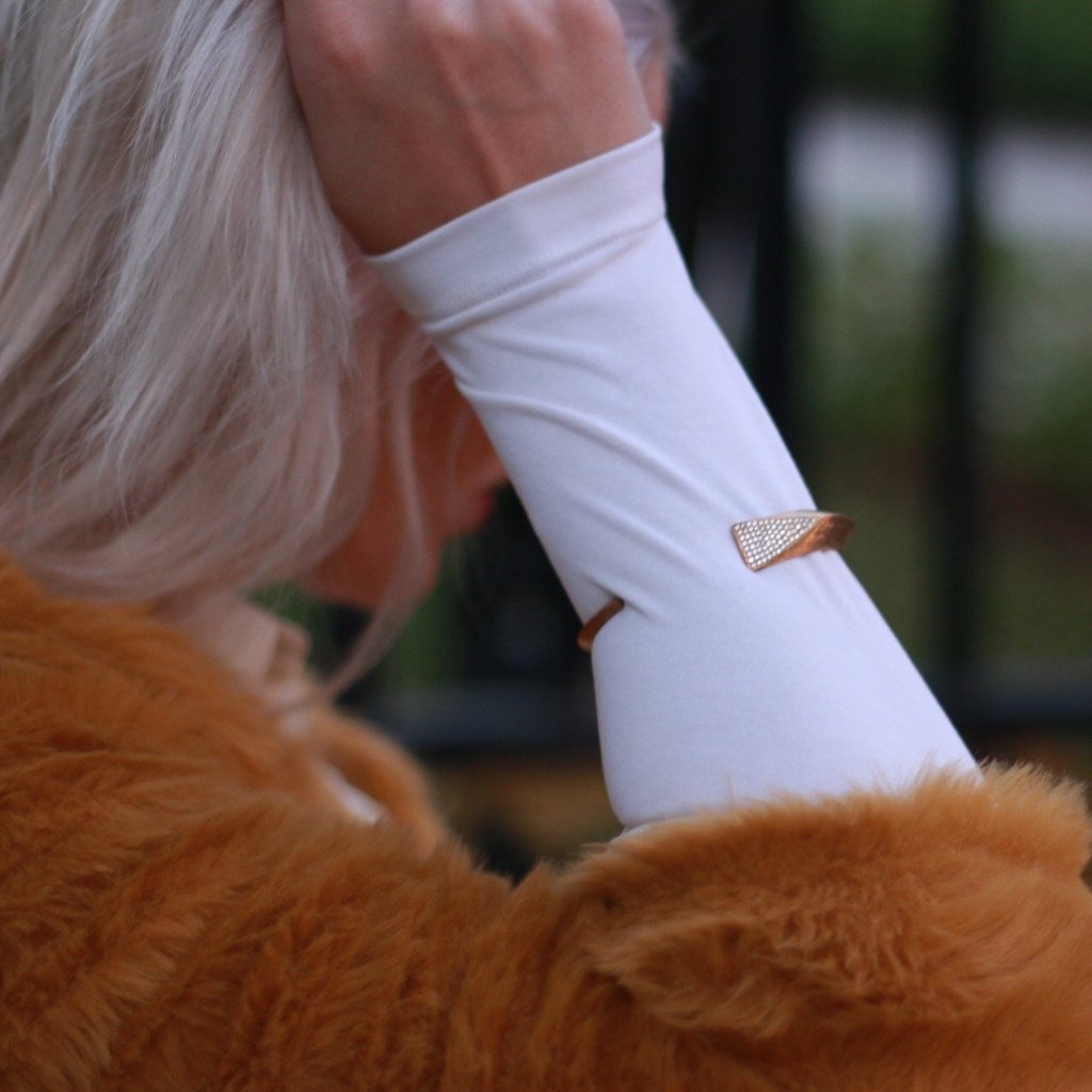 platinum blond wearing fur and white shirt wearing Mantra Dagger Corded Bracelet - gold, swarovski crystals