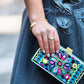 blogger Shira Rose holding clutch wearing Mantra Dagger Cuff With Swarovski Crystals
