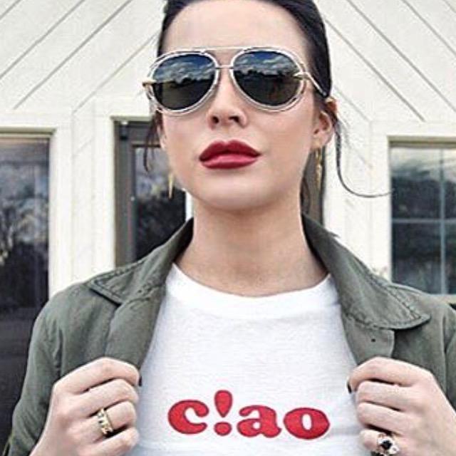 Blogger Taylor Stone wearing camouflage jacket white t shirt and Mantra Dagger Drop Earrings