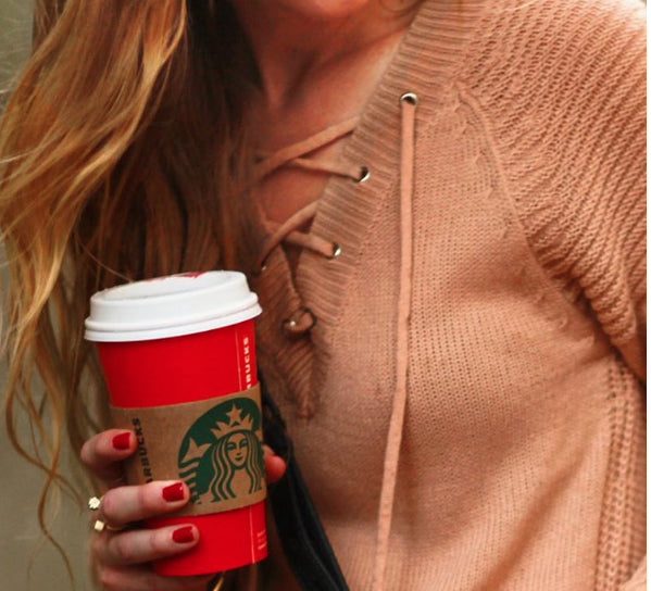 Blogger Upbeat Soles holding a cup of Starbucks coffee wearing Cube Ring