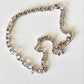 Riley - silver-toned metal chain necklace with a curb-style link pattern and rhodium plated push clasp, laid out on a plain white background.