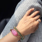 pink dignity Bracelet - Dress For Success Vancouver | Values Bracelet on striped pants