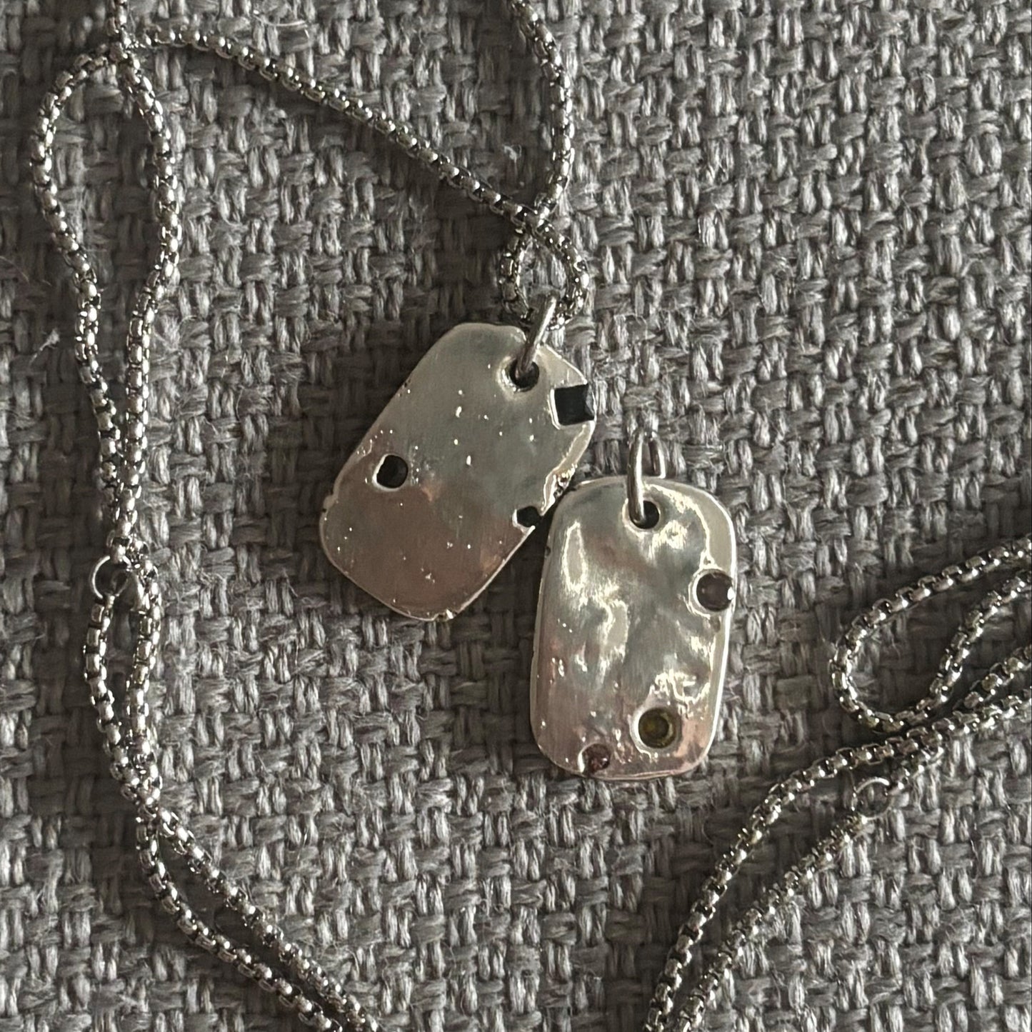 sand cast dog tags with lab sapphires 