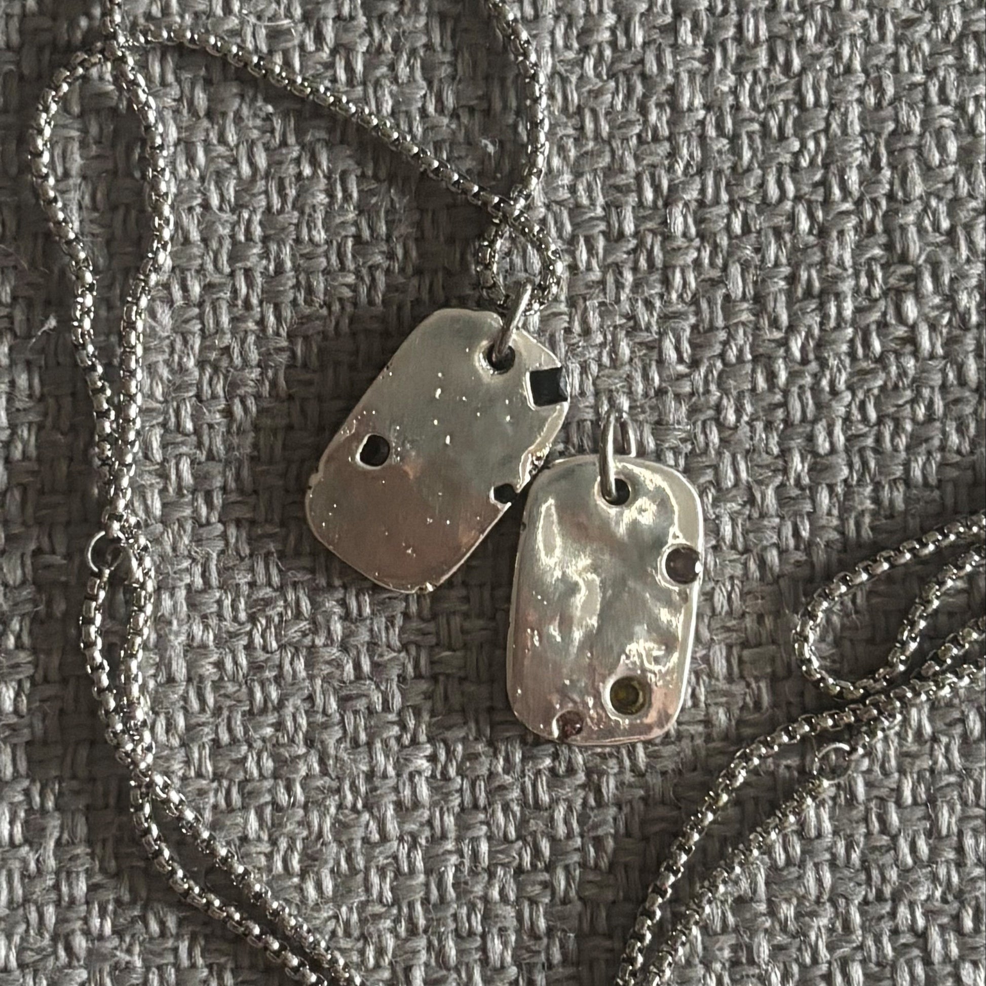 sand cast dog tags with lab sapphires 