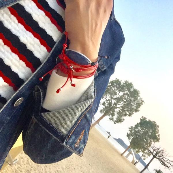 women at beach with denim jacket wears the Bracelet - String Of Destiny With Red Carnelian