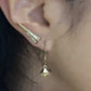 Woman wearing Mantra Dagger Earrings and Mantra Cube Earrings - Engraved