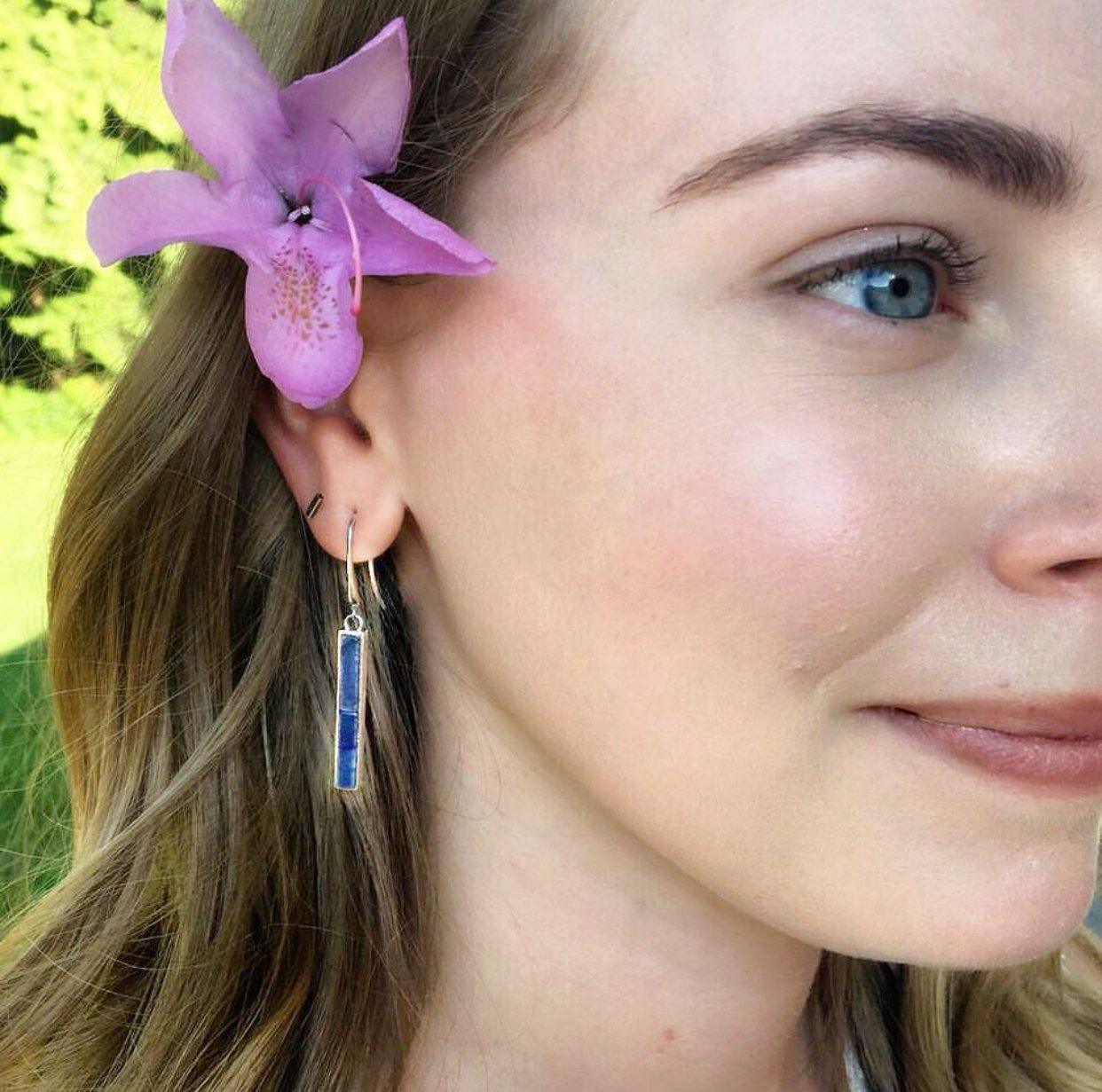 Young woman in garden wearing Mantra Long Rectagular Earring With Earth Stones