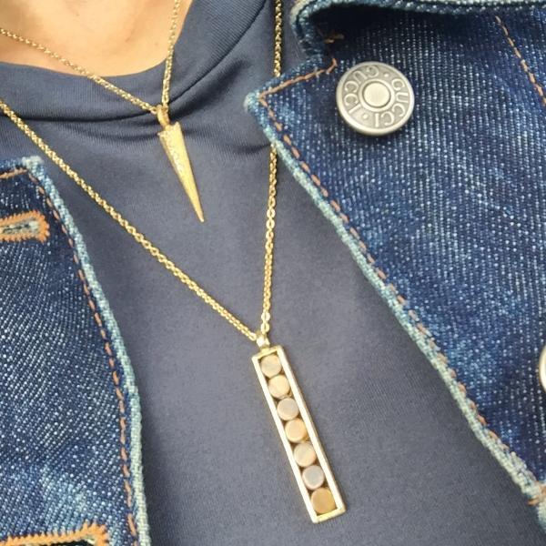 women in grey and denim jacket layering the Mantra Dagger Pendant Pavee Edge With Swarovski Crystals with Mantra Rectangle Pendant with Round Stones Necklace