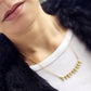 Woman wearing white shirt and black fur wearing Mantra Multi Triangle Necklace