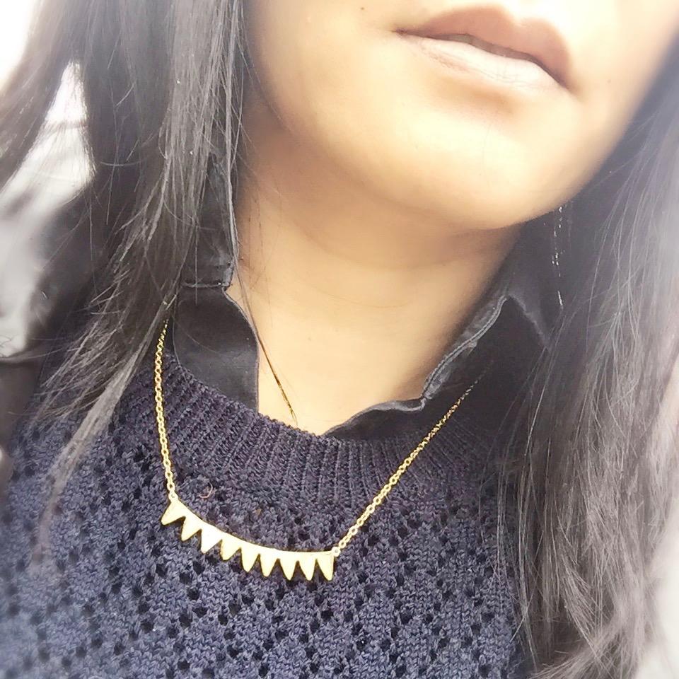 woman in navy sweater and black shirt wearing Mantra Multi Triangle Necklace