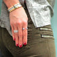 woman in grey and camouflage pants with hands on the side wearing Mantra Open Cube Ring with Swarovski Crystals