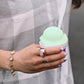 woman wearing Lattice Cocktail Ring - rose quartz while holding mint shaved ice
