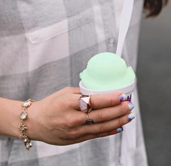 woman wearing Lattice Cocktail Ring - rose quartz while holding mint shaved ice