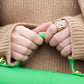 Blogger Veronica of Bittersweet Colours Ring wearing beige sweater holding green bag with Lattice Square Cocktail Ring