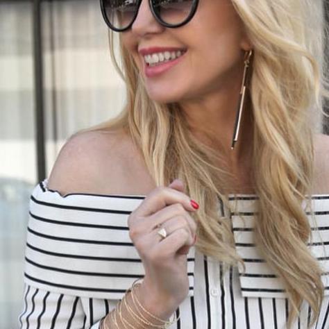 Blogger Kristi Elong of Currently Crushing in an off the shoulder shirt wearing Mantra Dagger Open Ring With White Sapphires