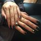 woman with hands crossed with a black manicure wearing Mantra Dagger Open Ring With White Sapphires
