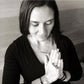 Black and White image of Khadija Muhaisen of Khadija's Adventures of the Soul in prayer position wearing Mantra Long Knuckle Ring With Edge