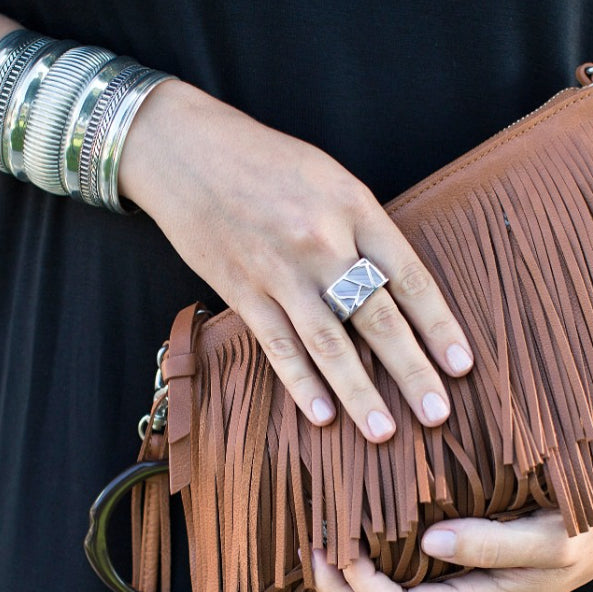 woman with multi bracelets holding fringe bag wearing Square Cocktail Ring