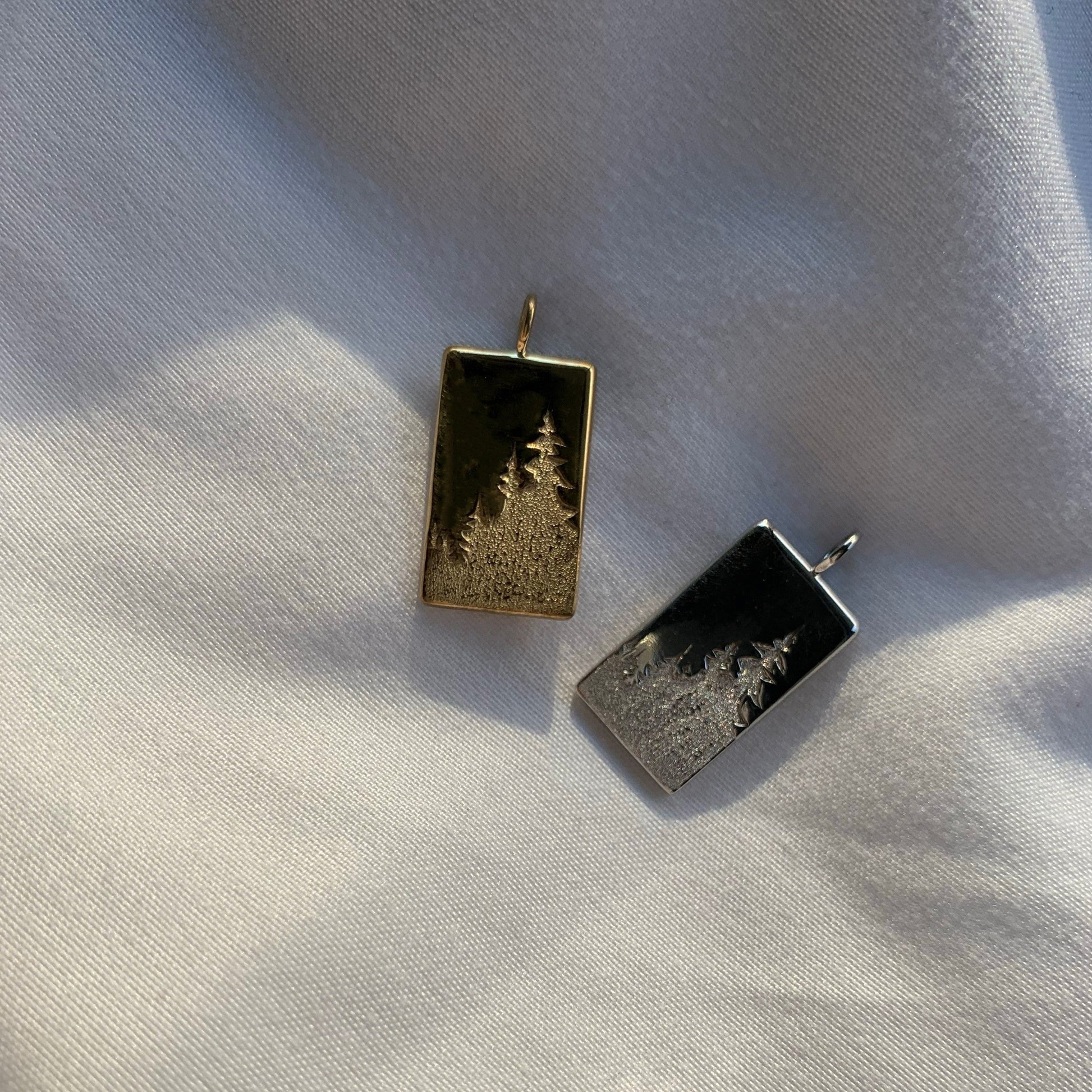 Rochelle Revelstoke Pendants Silver with Gold and Rhodium Plate on cloth